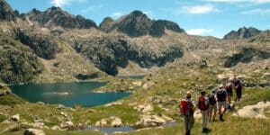 randonneurs près d'un lac, ciel bleu et sommets du Mercantour